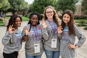 Four students making a W-C hand symbol to show Wildcat pride