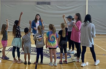 Teacher education major directs students in P.E. lesson.