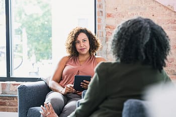 Attentive counselor listens to female patient, Bachelor of Science in Psychology