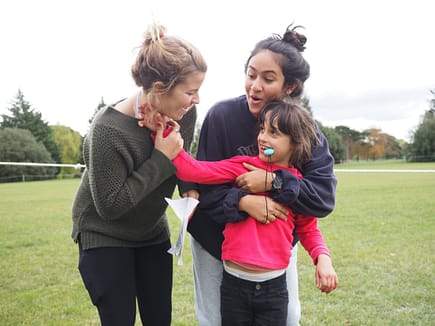 Amanda Bondy (left) and Cayla Savari interact with a KEEN participant.