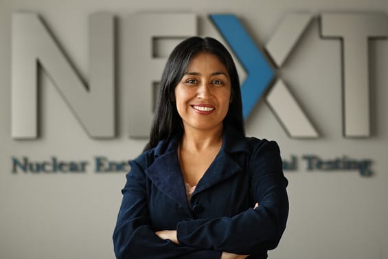 Rosario Gibbs smiling at camera in front of NEXT lab sign