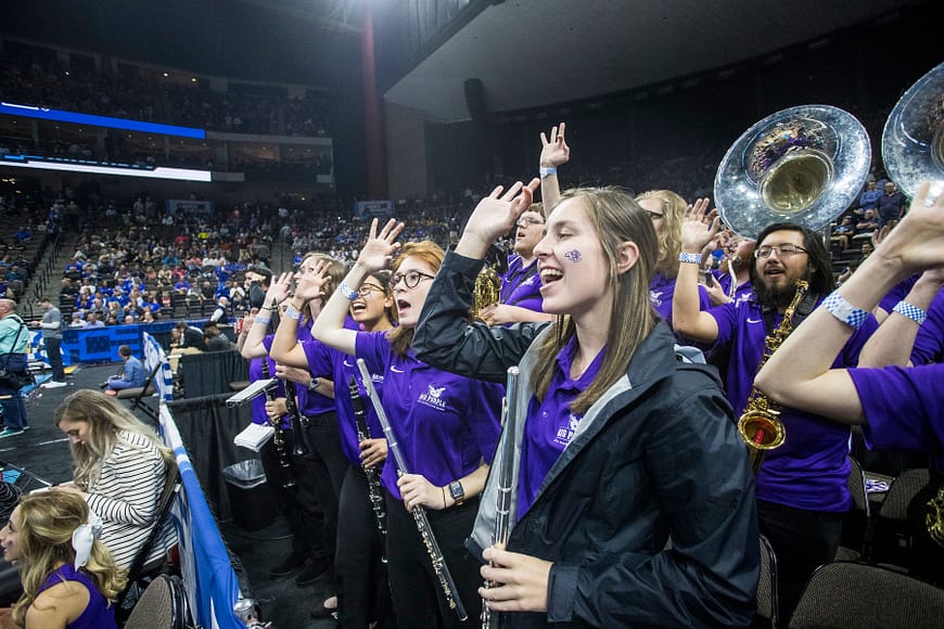 Between tunes, Big Purple basketball band members show their school spirit during Thursday night's ACU-Kentucky game in Jacksonville.