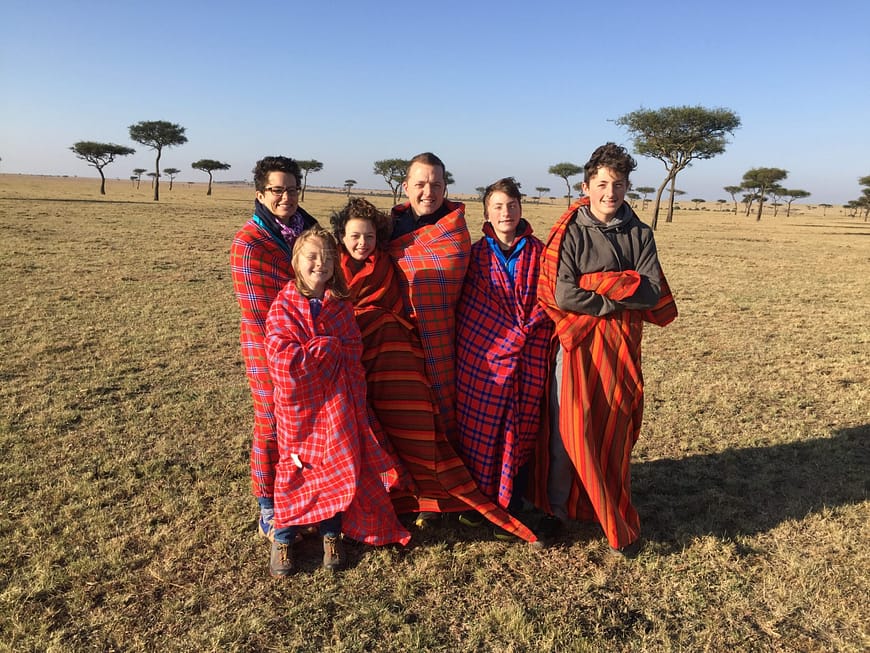 Will and Allison Caire with their children in Africa, wrapped in traditional blankets. From left are Allison, Sarah, Annie, Will, Peter and David.