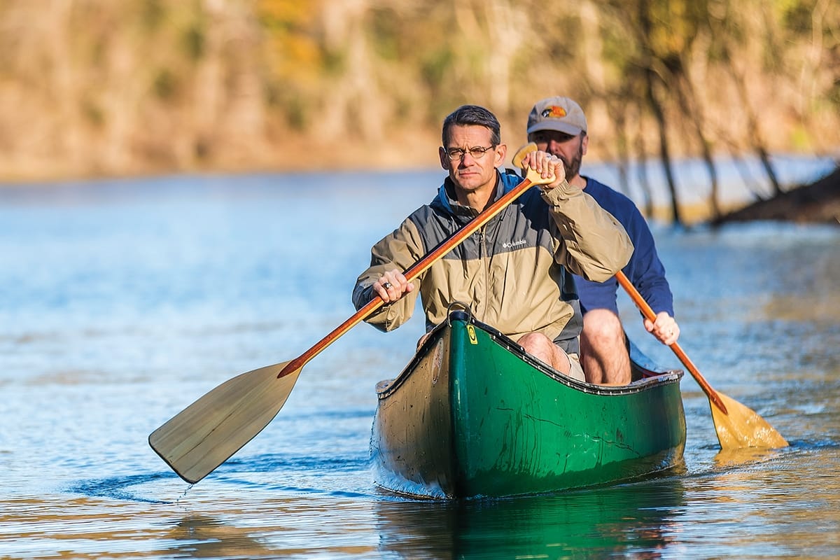 Lee McLeod (left) and Michael Pratt retrace waters in a Houston bayou where they used a canoe to rescue people last August (see inset photo). With a pricetag of $125 billion, Hurricane Harvey tied 2005 storm Katrina in causing the most damage of any tropical cyclone in U.S. history.