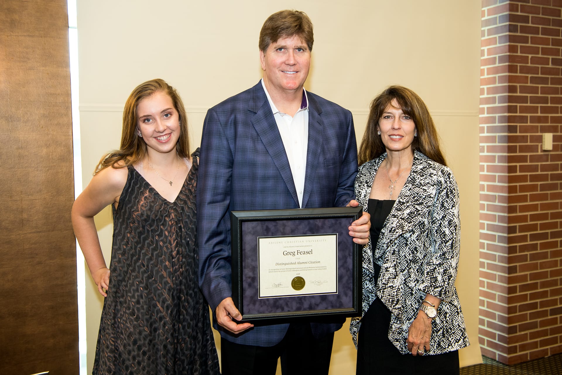 Greg Feasel ('81) is joined by wife, Lynn, and daughter, Zoie, at his Distinguished Alumni Citation ceremony on Aug. 10, 2018, in Denver, Colorado. 