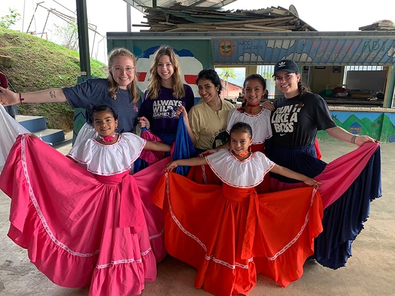 ACU students (from left) Madeline Dayton, Katey Loveless, Mafer Hernandez and Alison Zuniga are shown local dances by children in the village of Mollejones. The students were part of a Study Abroad course offered by the College of Business Administration.